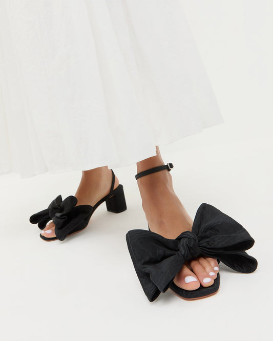 Carmen Black Moiré Bow Sandal in black moiré and Clarissa Dress in white cotton.