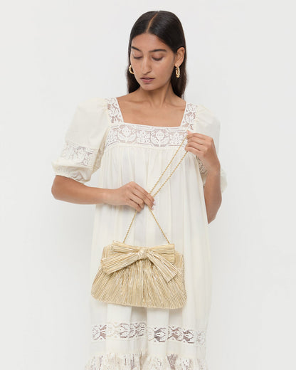 Rayne Gold Bow Clutch in gold pleated lamé