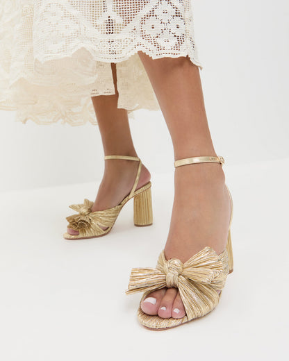 Camellia Gold Pleated Bow Heel in gold lamé and Jo Puff Sleeve Dress in cream cotton.